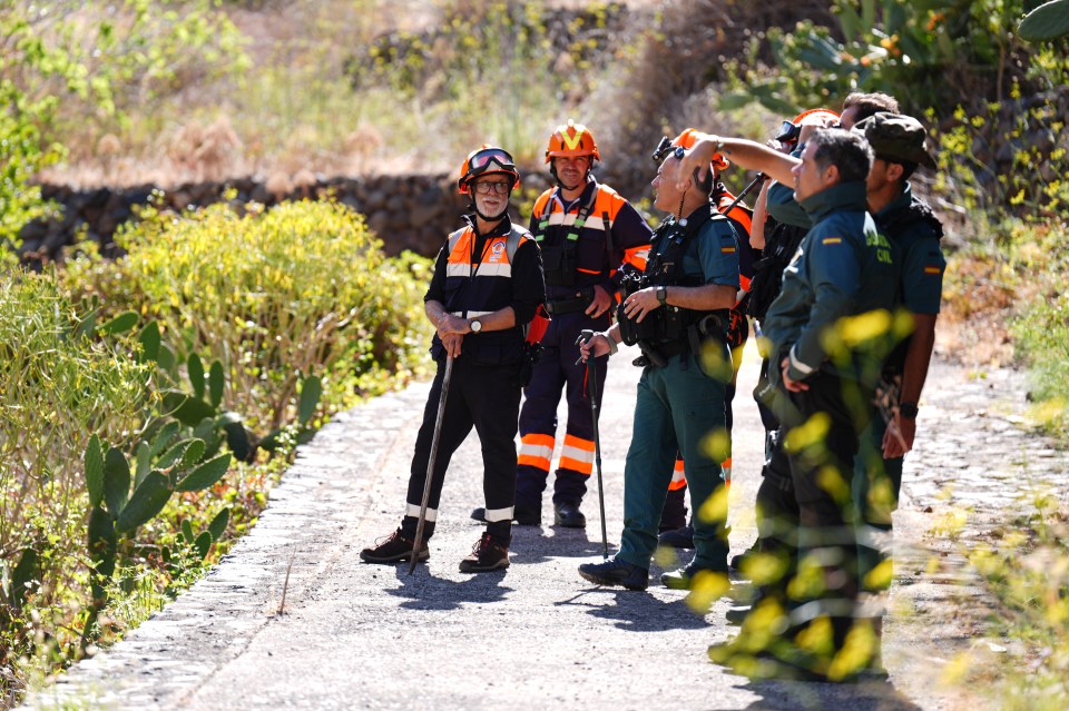 a group of men are standing on a path and one of them is wearing a shirt that says ' guardia civil ' on it