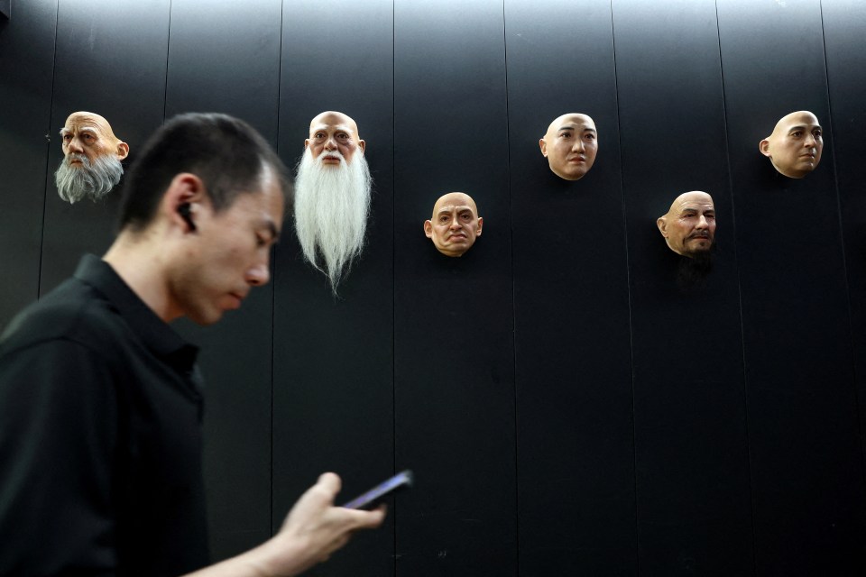 Disembodied silicone heads sit along the walls of China's haunting humanoid robot factory