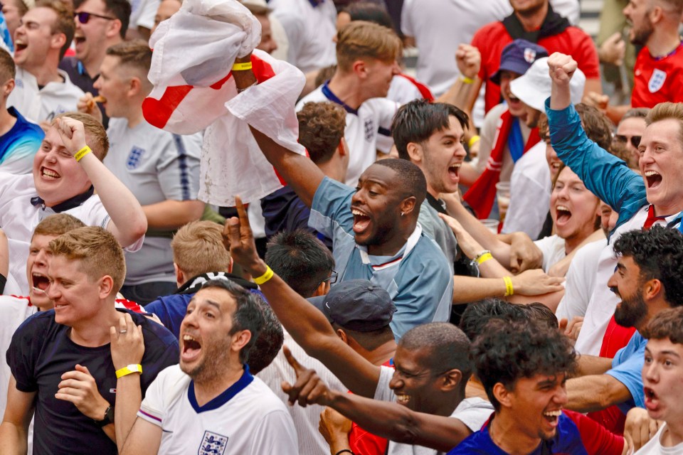 a crowd of people with one wearing a shirt that says ' england ' on it