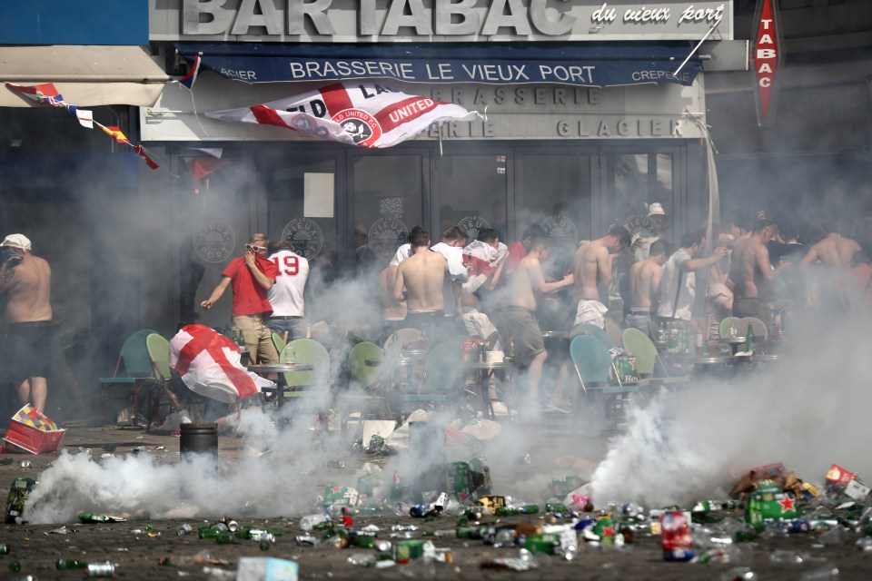 England fans react to tear gas used by police during clashes.