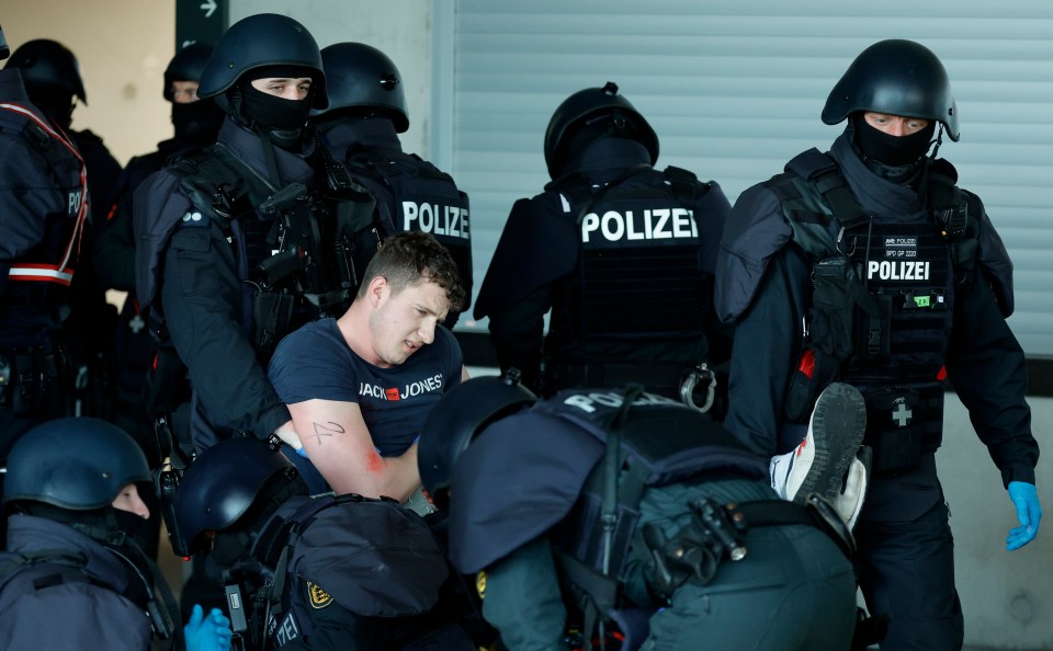 German police tend to a mock casualty as they take part in an operational drill at the Stuttgart Arena in May