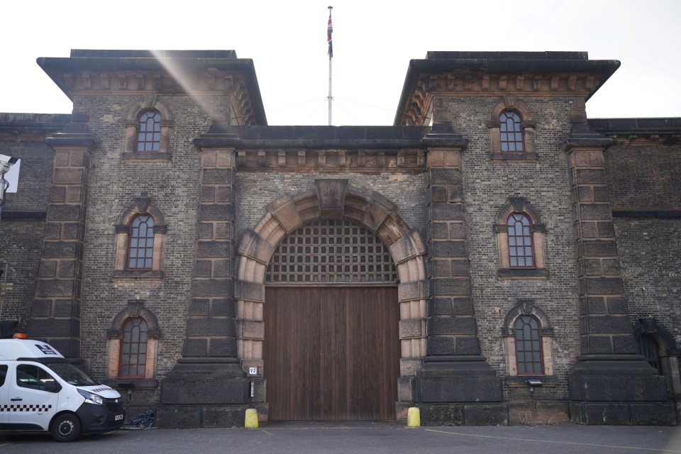 a white van is parked in front of a large brick building