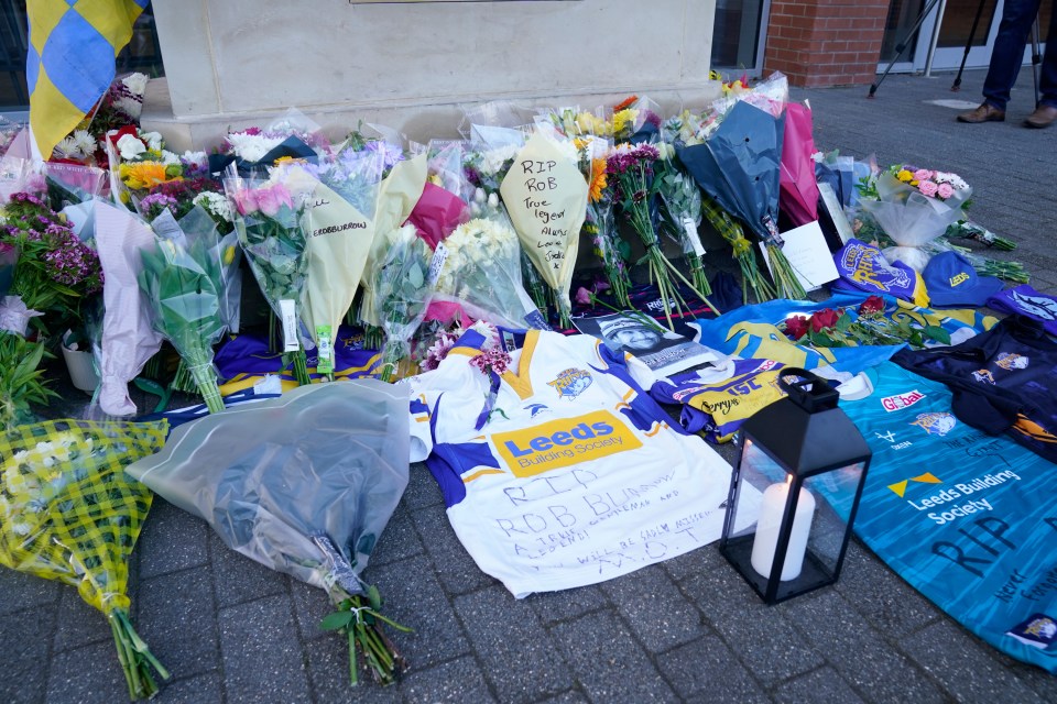 Heartbroken fans have laid down shirts and flowers in memory of the star outside Leeds Rhinos' stadium