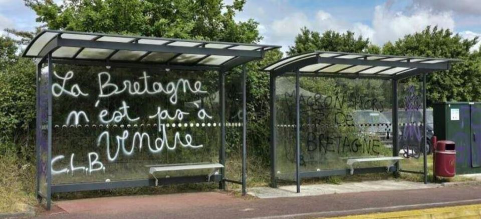 Graffiti appeared on a prominent bus shelter 'making reference' to President Macron