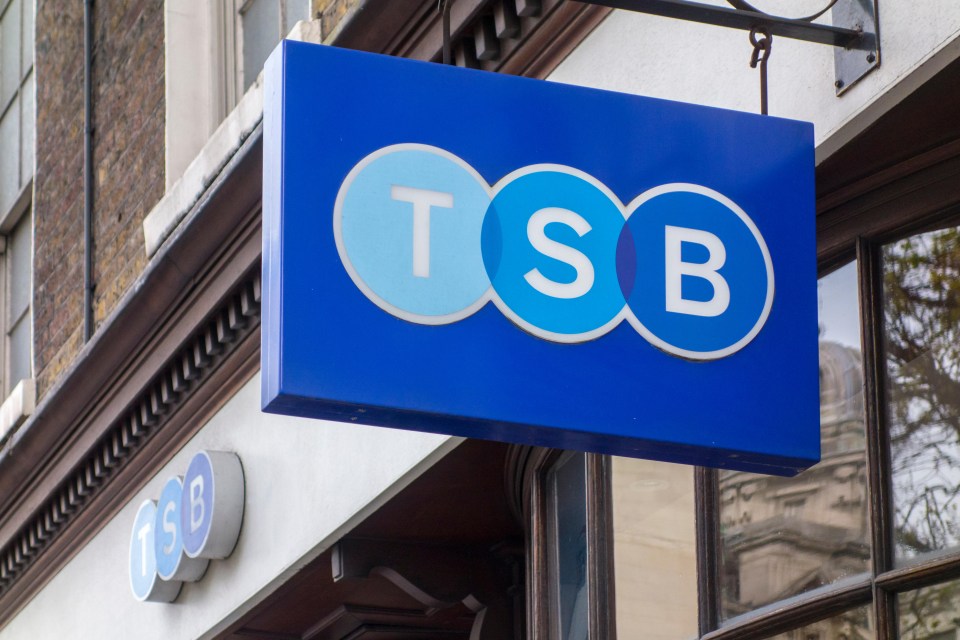 a blue tsb sign hangs from the side of a building