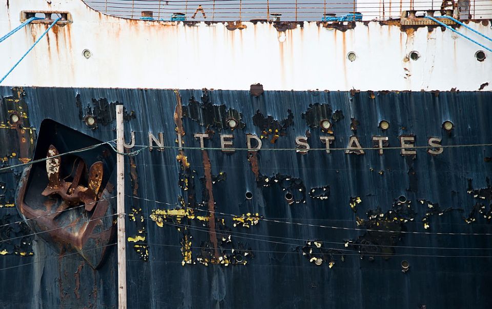 the word united states is on the side of a rusty ship