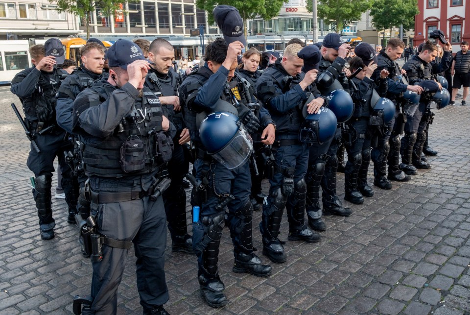 German police officers pay their respects to the man after hearing about his tragic death