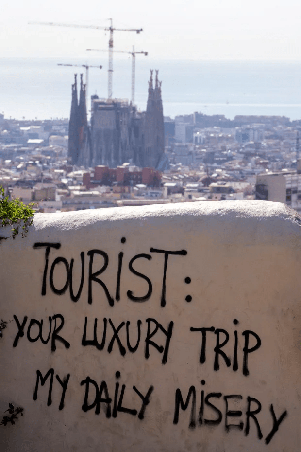 Anti-tourist graffiti seen at the Guell Park in Barcelona