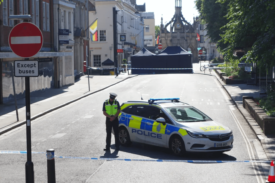 a police car is parked in front of a no buses sign