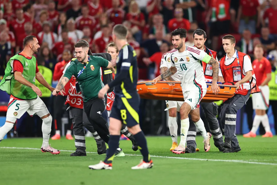 Dominik Szoboszlai helps bring the stretcher onto the field