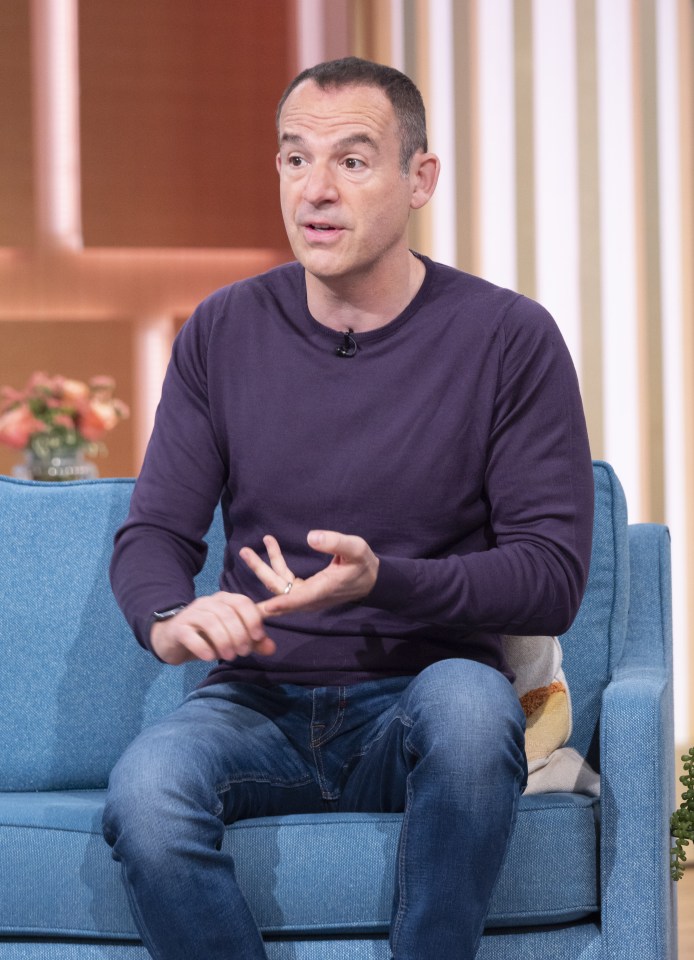 a man in a purple shirt is sitting on a blue couch