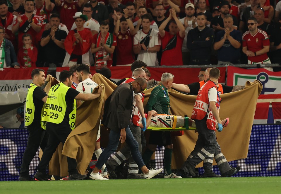 Medics carried Barnabas Varga off the field behind a screen