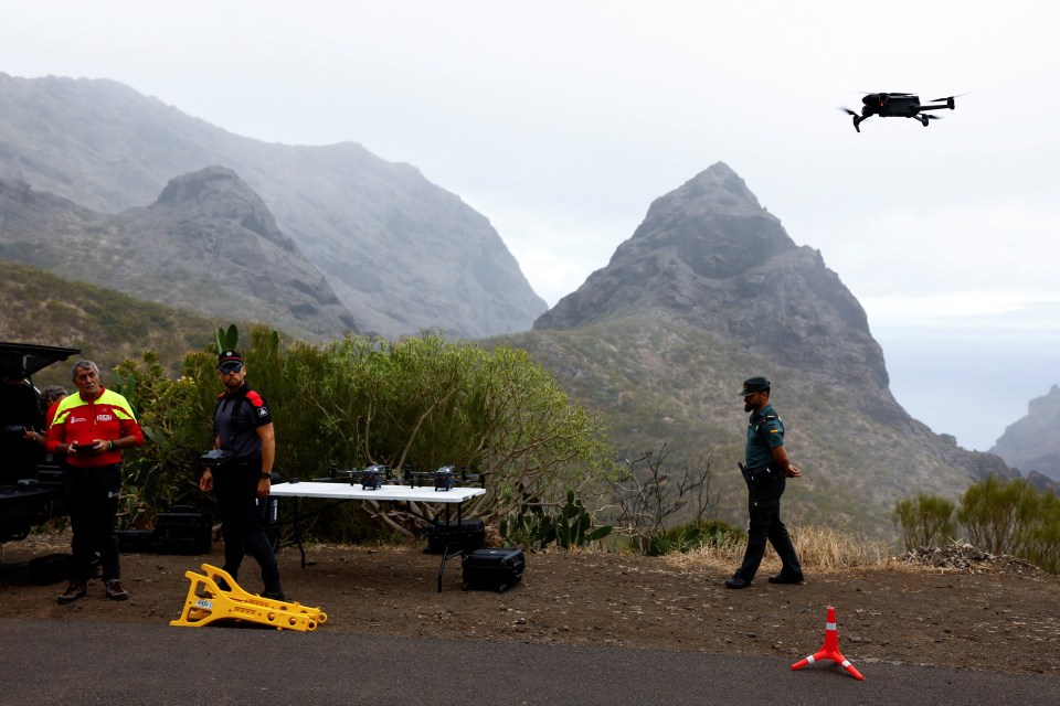 two police officers are standing in front of a table with a sign that says ' atencion ' on it