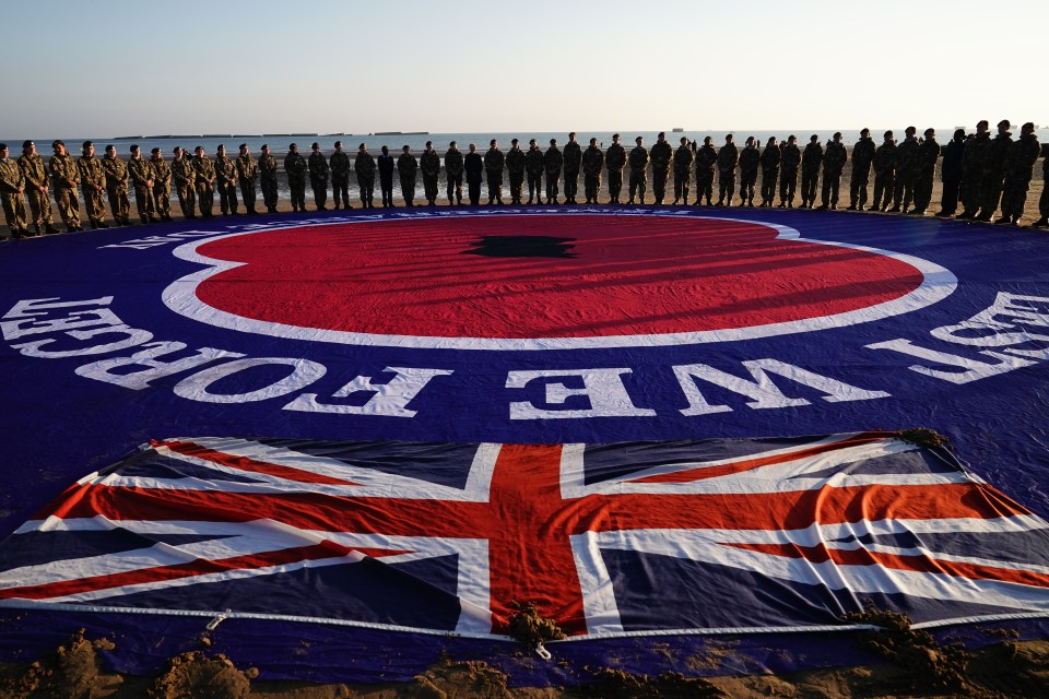 Military personnel gathered at Gold Beach in Arromanches this morning