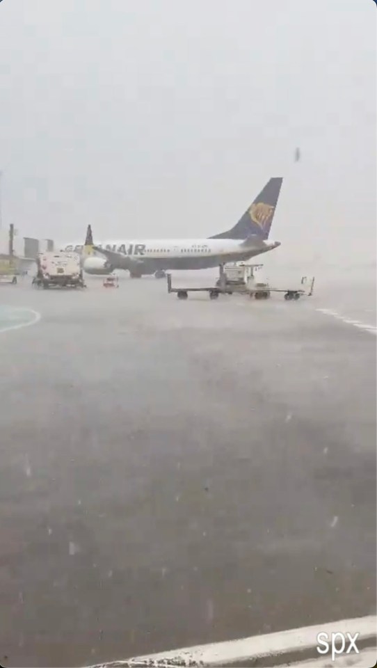 A Ryanair flight was seen stranded on the runway amid the torrential downpours