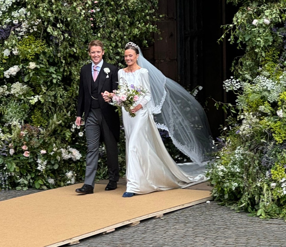 The newly married couple beamed as they left the chapel