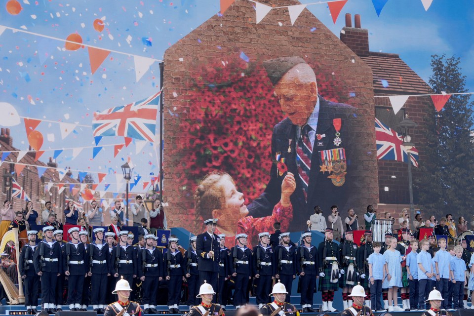 Pictures are shown on a screen during the emotional D-Day national commemoration