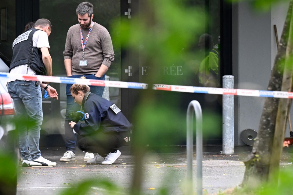 Police officers are at work on the site of the shooting in Thionville