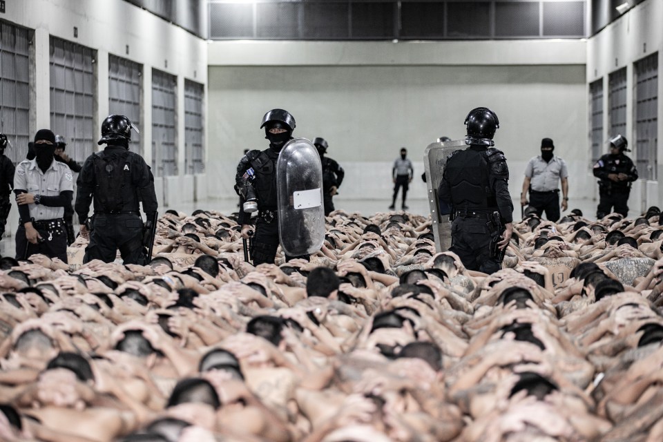 Prisoners are forced to sit close to each other during the transfer