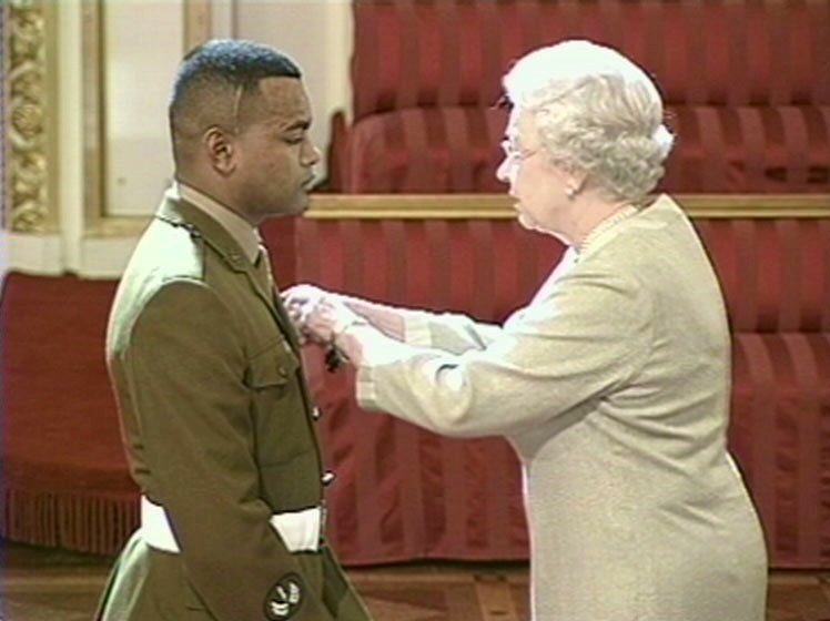 Johnson being presented with the Victoria Cross by Queen Elizabeth II in 2005