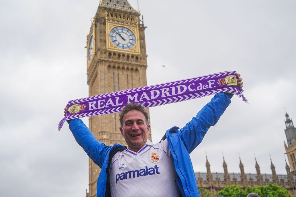 One Real Madrid fan proudly raises his scarf for a snap