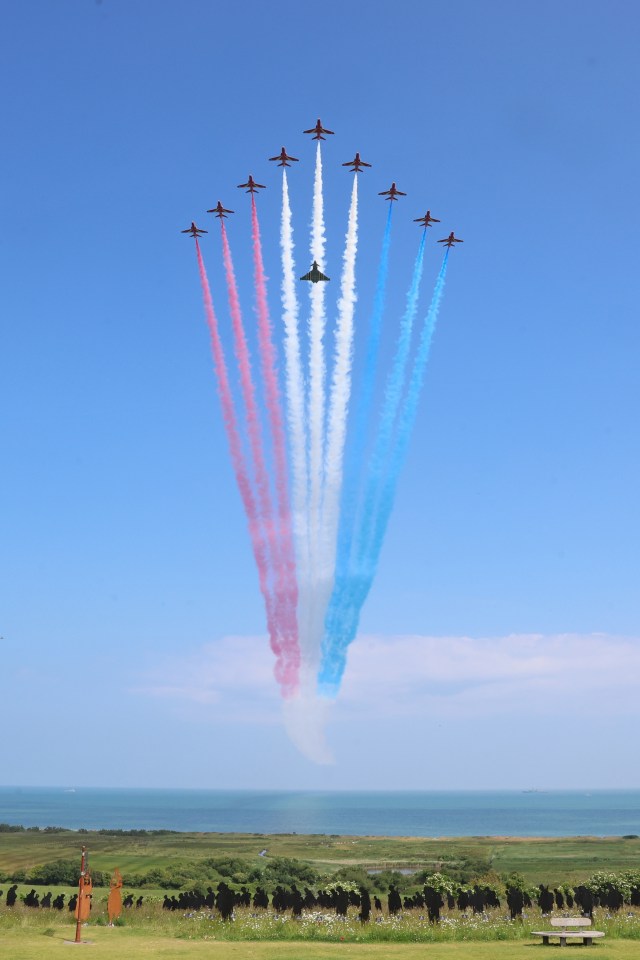 The Red Arrows with a Eurofighter EF-200 Typhoon accompanying them during a flypast