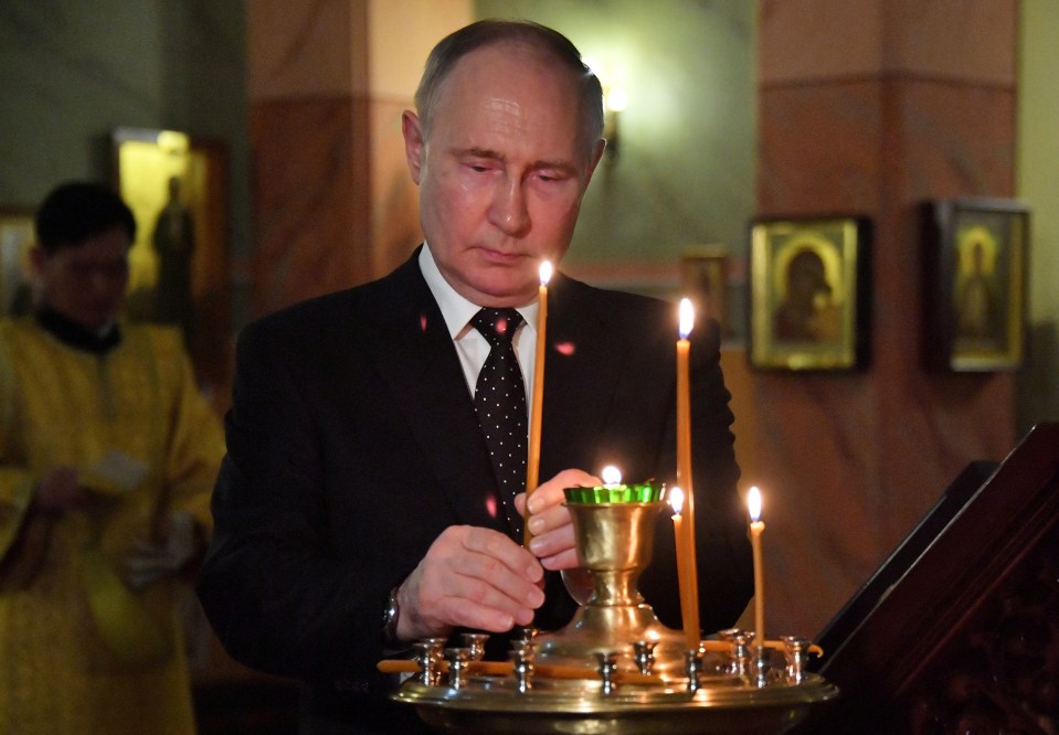 Russia’s President Vladimir Putin lights a candle as he visits the Church of the Holy Life-Giving Trinity in Pyongyang, North Korea