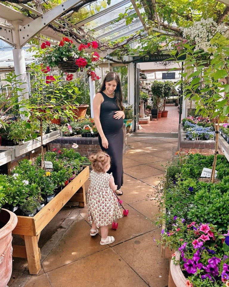 She showed off her bump at a garden centre with her daughter Grace