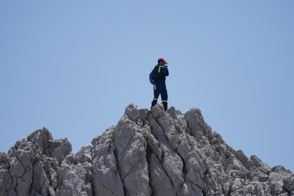 A rescuer searching from a high point today