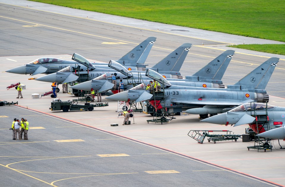 a row of fighter jets with the numbers 11-33 on the tail