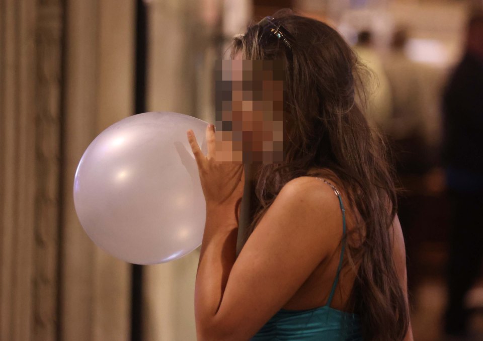 One reveller inhaling laughing gas from a balloon