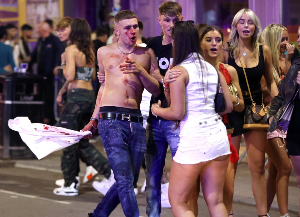 One topless partygoer covered in blood on Duncan Street, in Leeds