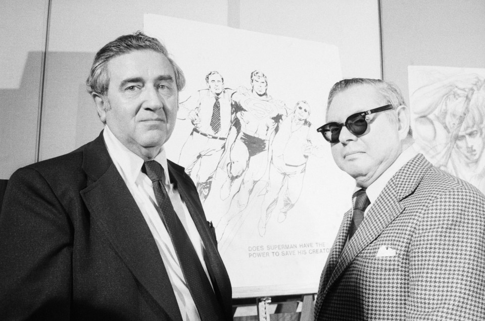 Superman creators Jerry Siegel and Joe Shuster posing in front of one of their sketches