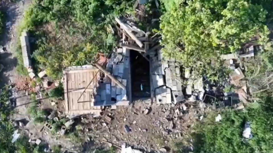 A Ukrainian drone drops a bomb on Russian soldiers hiding in a damaged building on the frontline of Ukraine