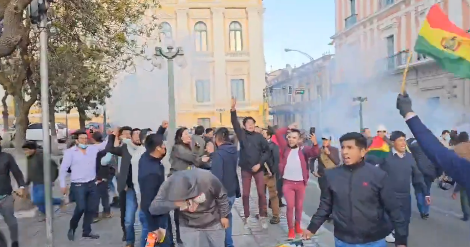 Bolivians chant and wave their national flag after the coup was botched