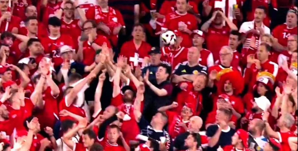 A Switzerland fan was struck in the face by a stray football last night