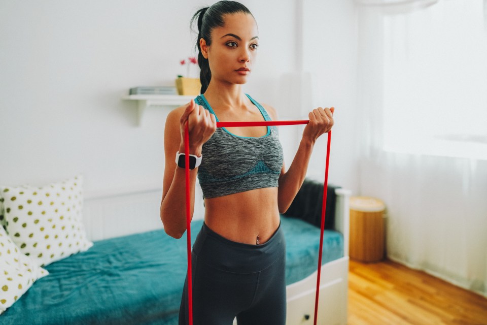 Use a resistance band to do bicep curls, keeping your elbows tight to your body