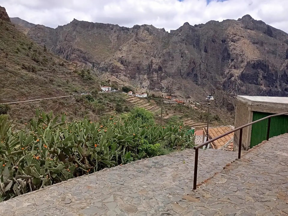 a staircase leading up to a valley with mountains in the background