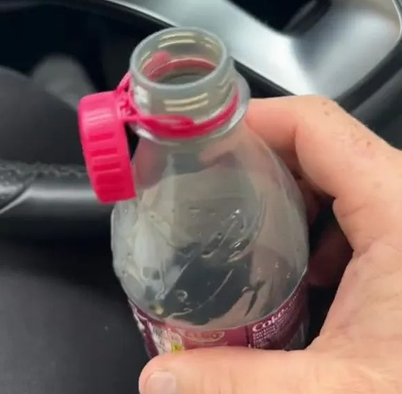 The Coca Cola fan opened the lid and pulled it over the top of the bottle instead of pulling it back