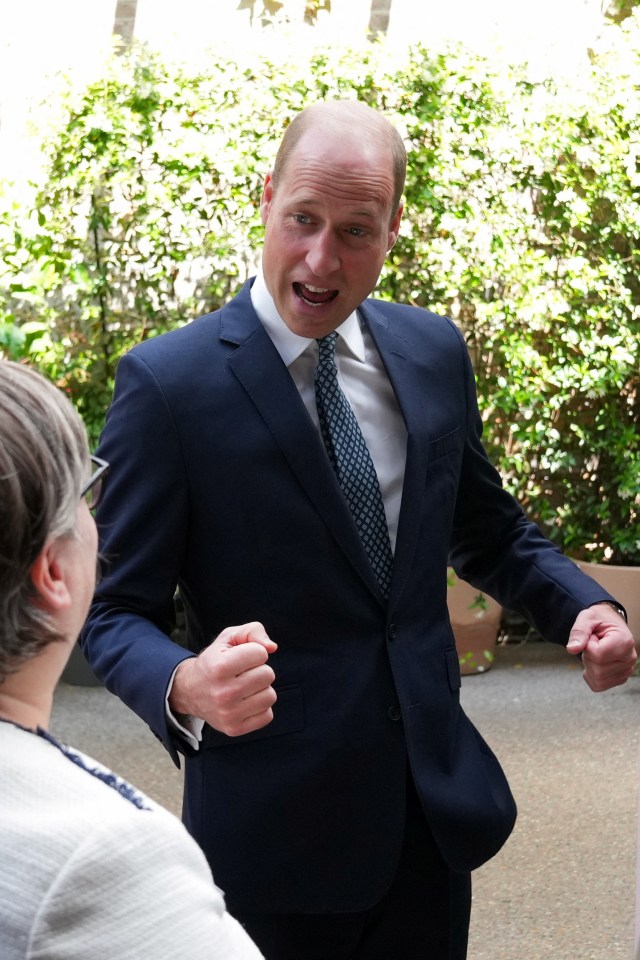 a man in a suit and tie is talking to a woman