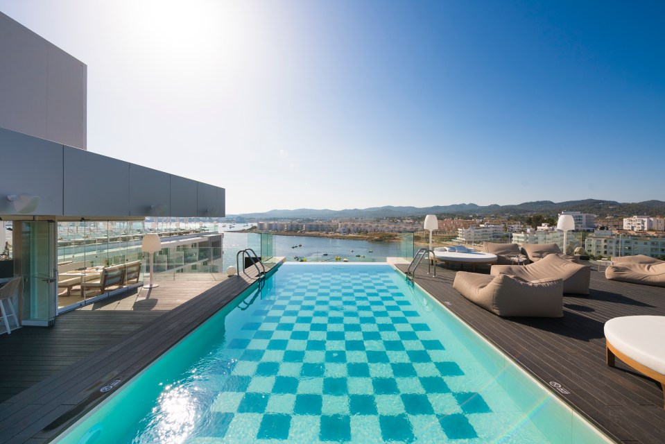 The rooftop infinity pool with views across the bay