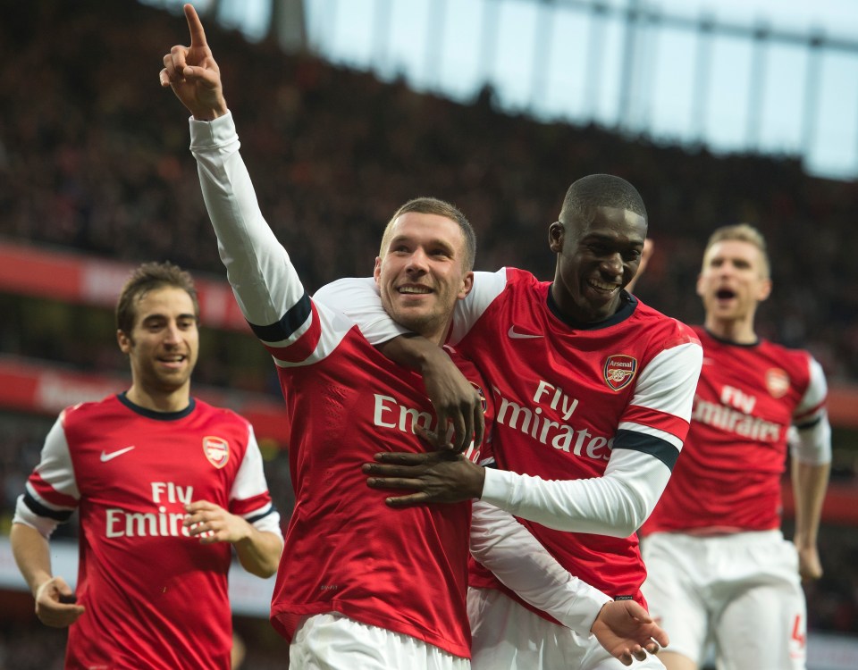 a group of soccer players are wearing fly emirates jerseys