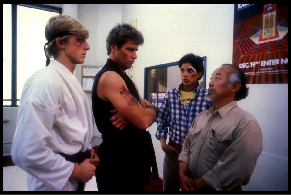 Johnny Lawrence, far left, and John Kreese – actors William Zabka and Martin Kove – stare down Daniel and mentor Mr Miyagi (Pat Morita) in The Karate Kid