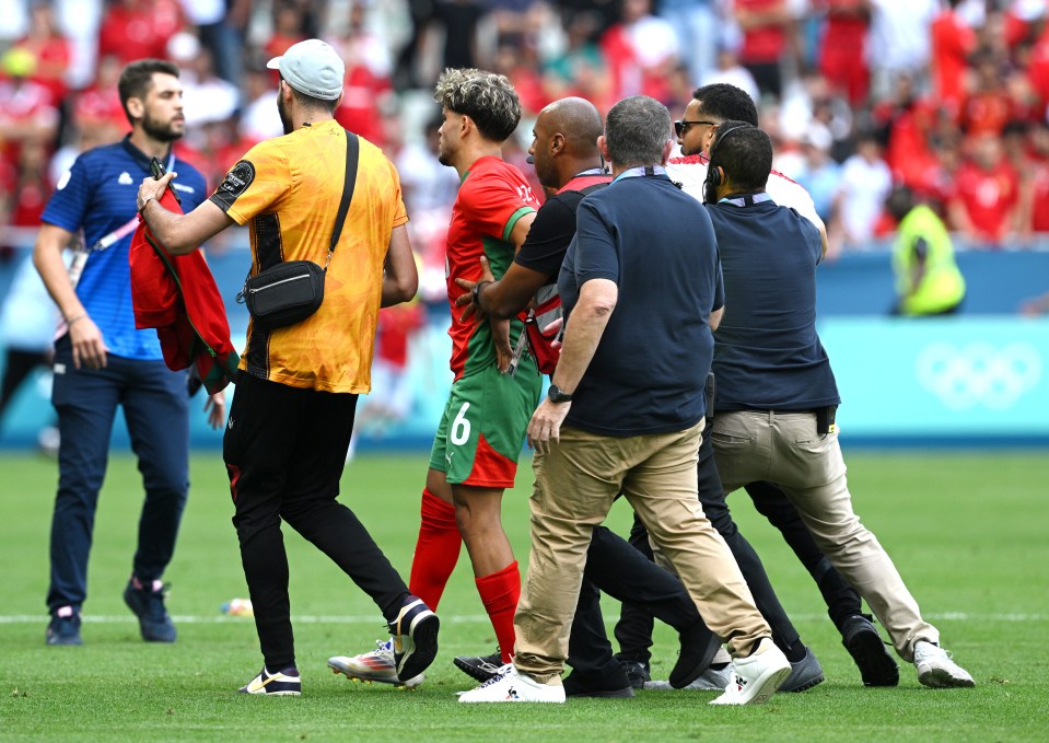 Morocco players were escorted from the pitch