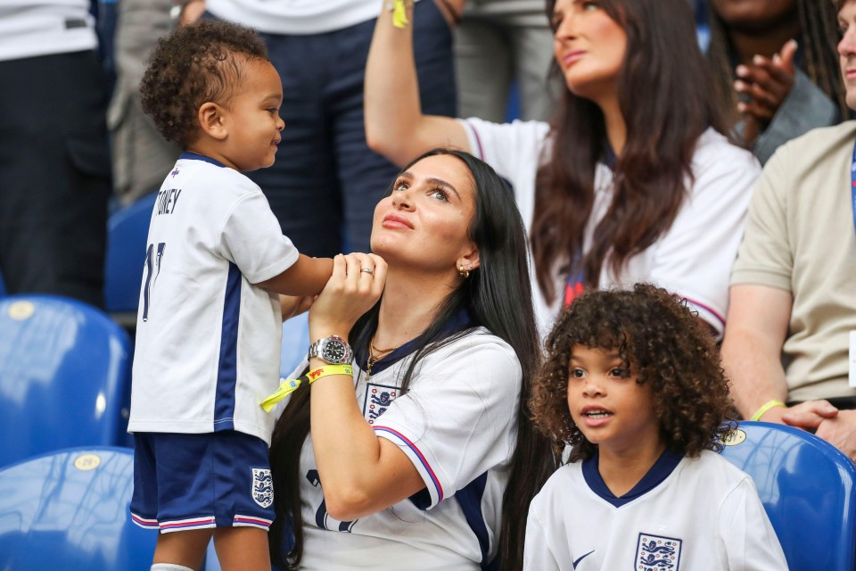 a little boy with the number 11 on his shirt