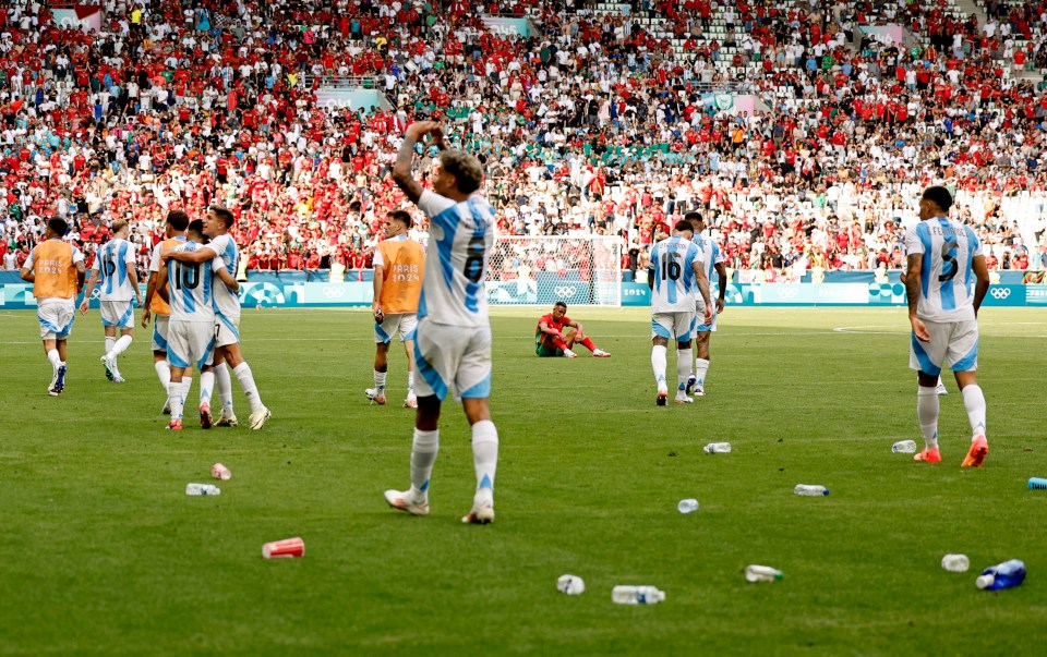 a group of soccer players on a field with one wearing the number 16