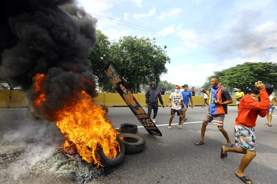 Demonstrators set a barricade on fire