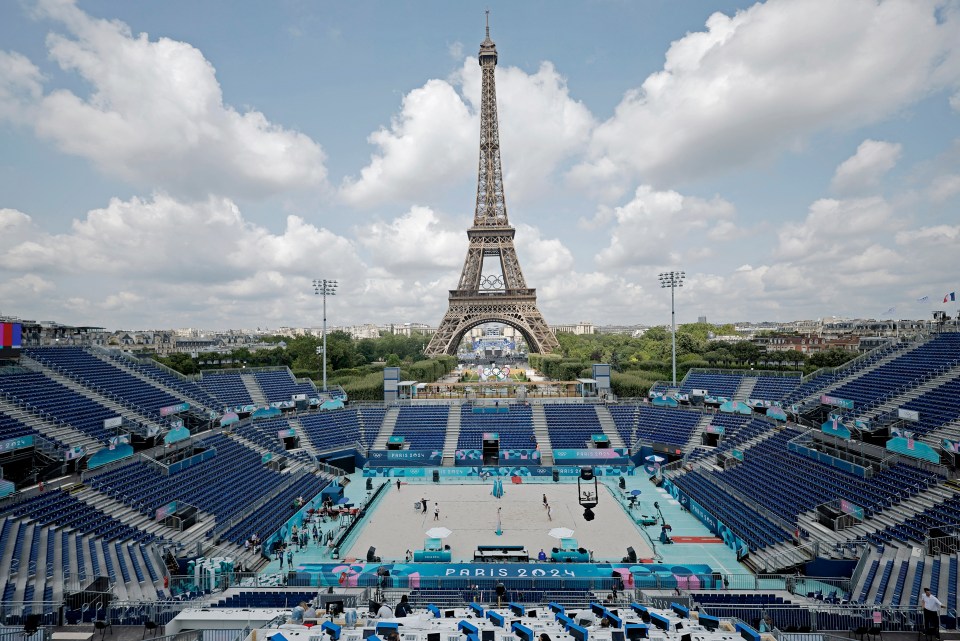 the eiffel tower is behind a stadium that says paris 2024