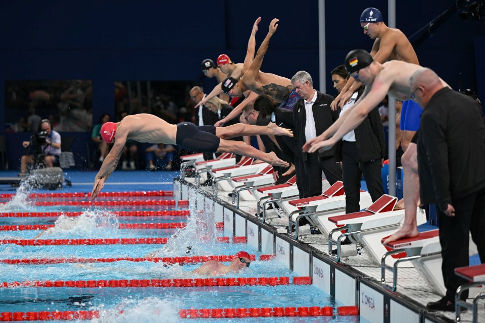 a group of swimmers are getting ready to dive into the pool