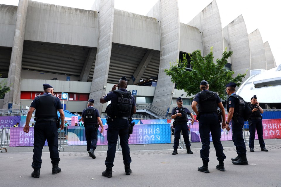 Armed Police stand guard on the streets outside the Parc des Princes stadium